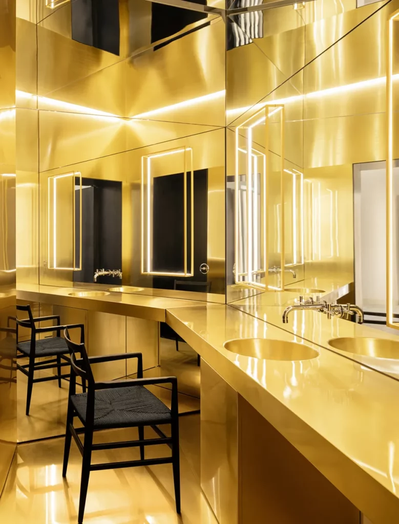 Spazio interno Sotherga con rivestimenti in ottone lucido e specchi retroilluminati, arredi bespoke su misura realizzati da Antonacci Falegnamerie